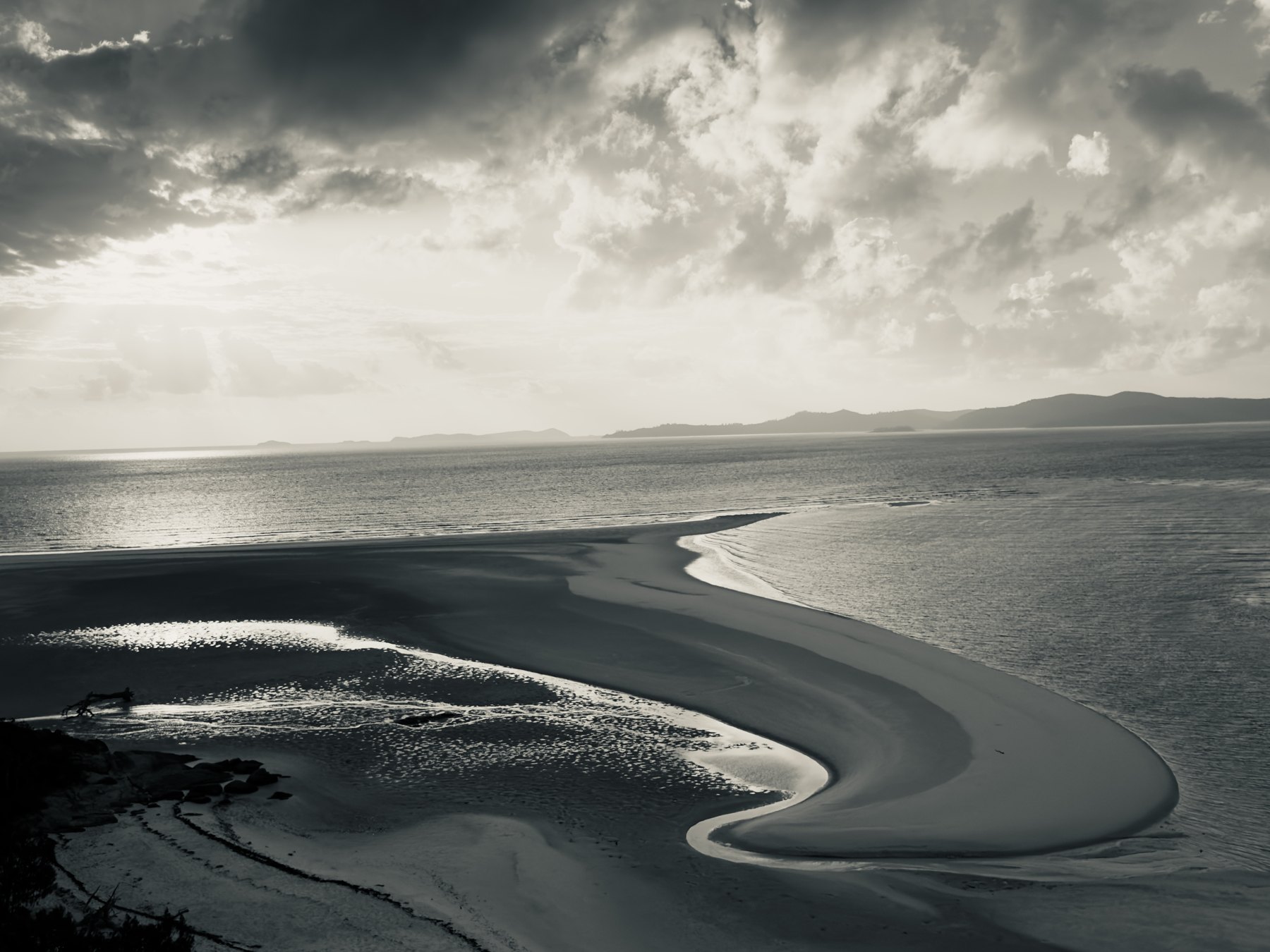 A curving shoreline beneath an open sky
